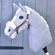 Grey Hobby Horse with a white mane wearing the cognac brown halter with white fur on the crown and front of the noseband