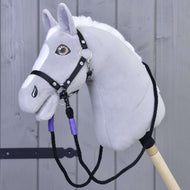Grey Hobby Horse with a white mane and black halter, the lilac-wrapped rope reins hanging in a loop below