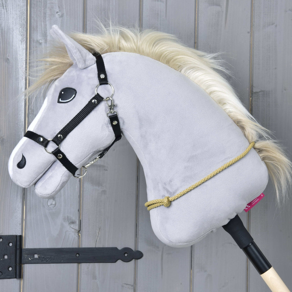 Grey Hobby Horse in a black halter with the sand-coloured Cordeo Nature knotted around the base of its neck