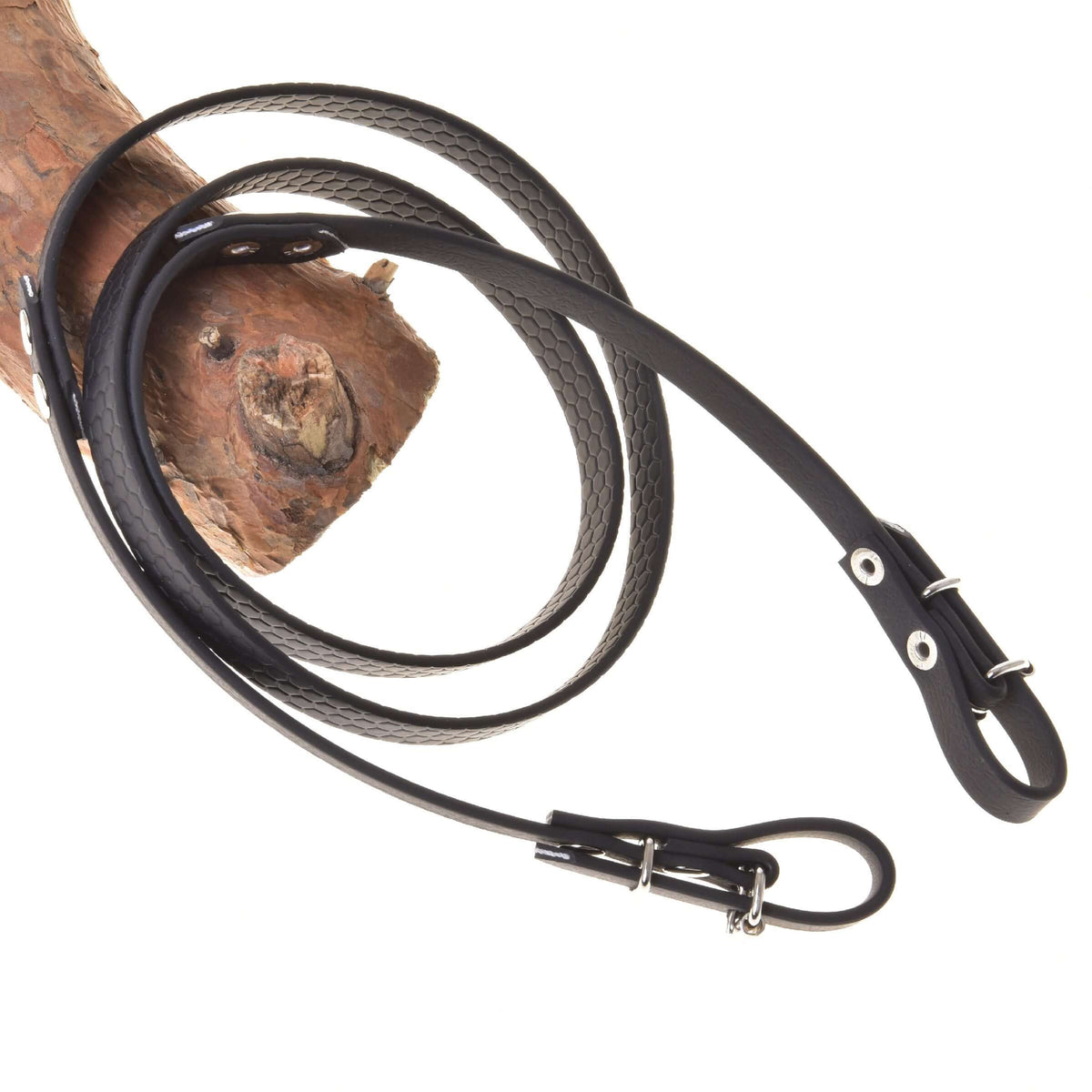 Hobby Horse Rubberized reins black by LarDen with honeycomb texture and silver buckles, draped over a branch