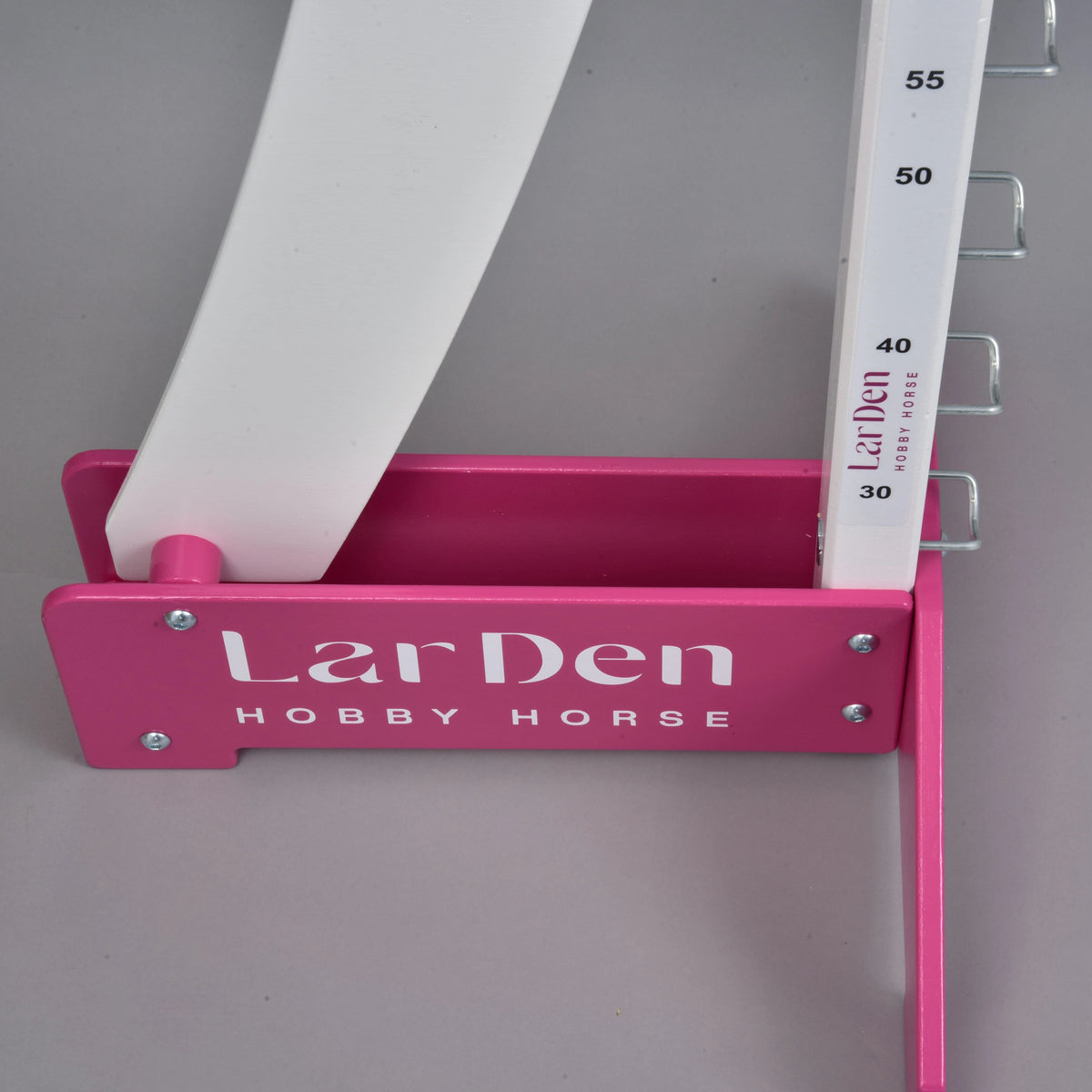 Close-up of a pink foot with white LarDen Hobby Horse lettering, holding the post marked from 30 to 55 cm