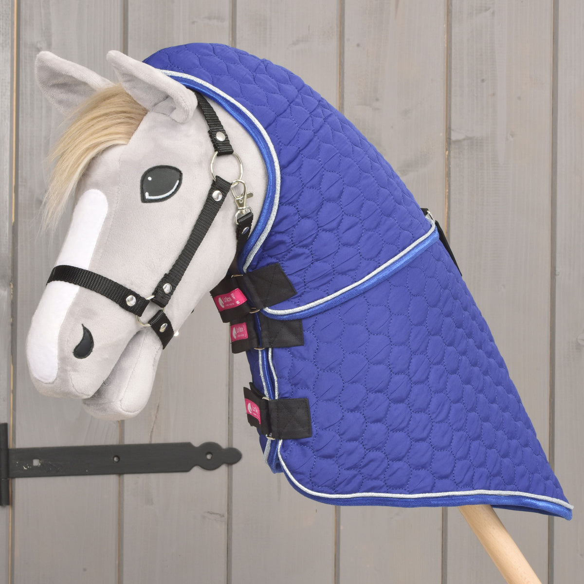 Grey Hobby Horse in a black halter wearing the Bluebell blanket with its neck cover reaching up to the ears