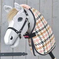 Grey Hobby Horse in a black halter wearing the houndstooth Stable Blanket Country Rose with a pink curly fleece collar
