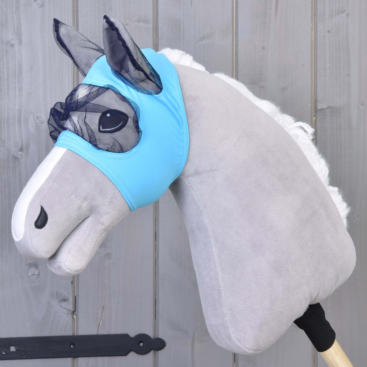 Hobby Horse Fly Mask by LarDen, light blue stretch fabric with navy mesh over the eyes and ears, on a grey plush head