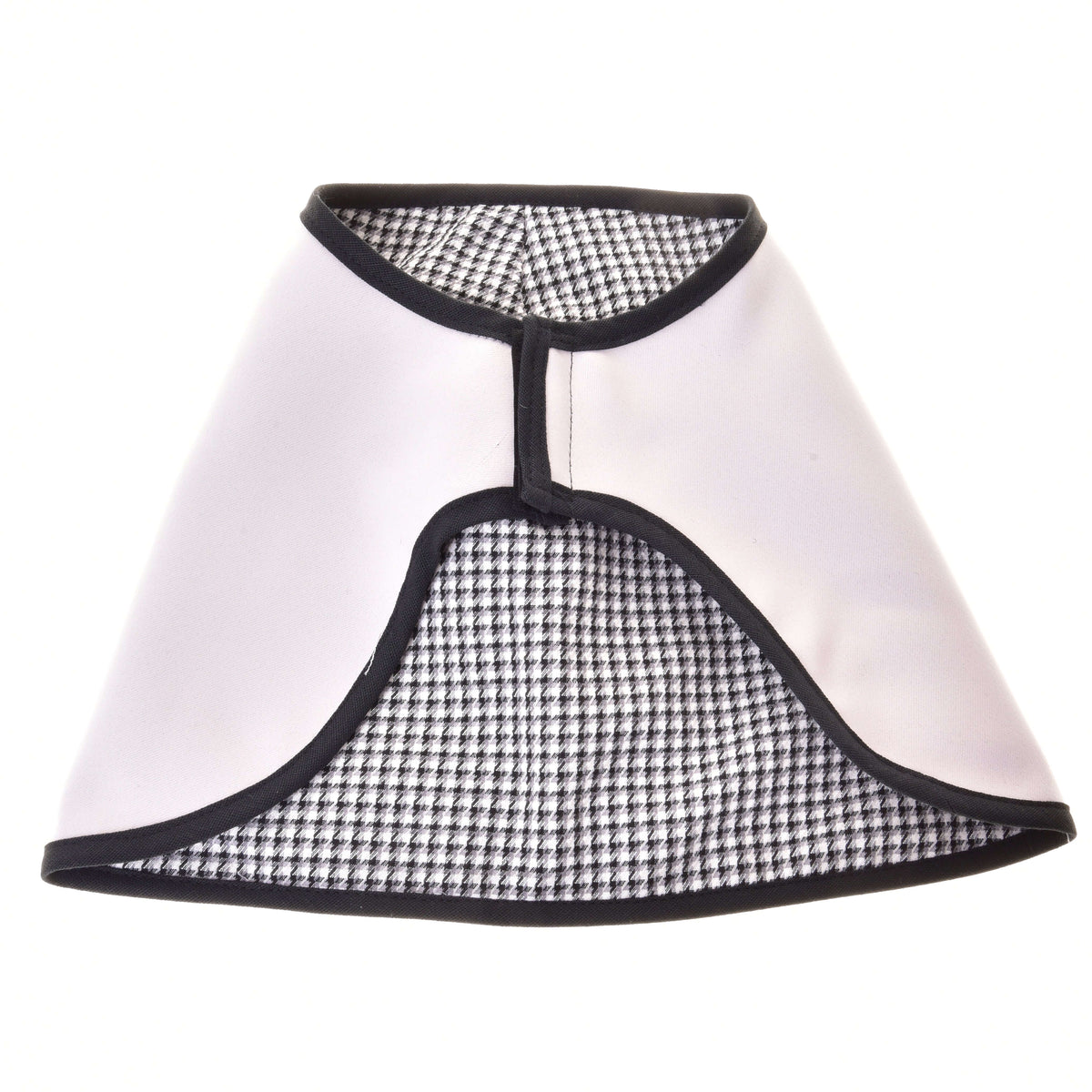 The reversible Hobby Horse blanket laid flat with the light side out, showing the black and white houndstooth lining