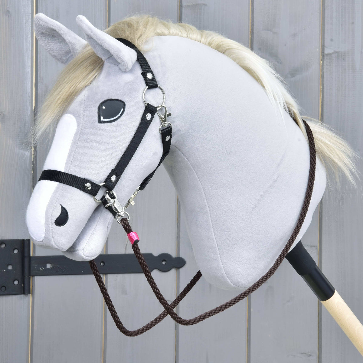 Brown rope reins from Rope set Noir Cocoa clipped to the black webbing halter of a grey Hobby Horse, pink wrap by the clip