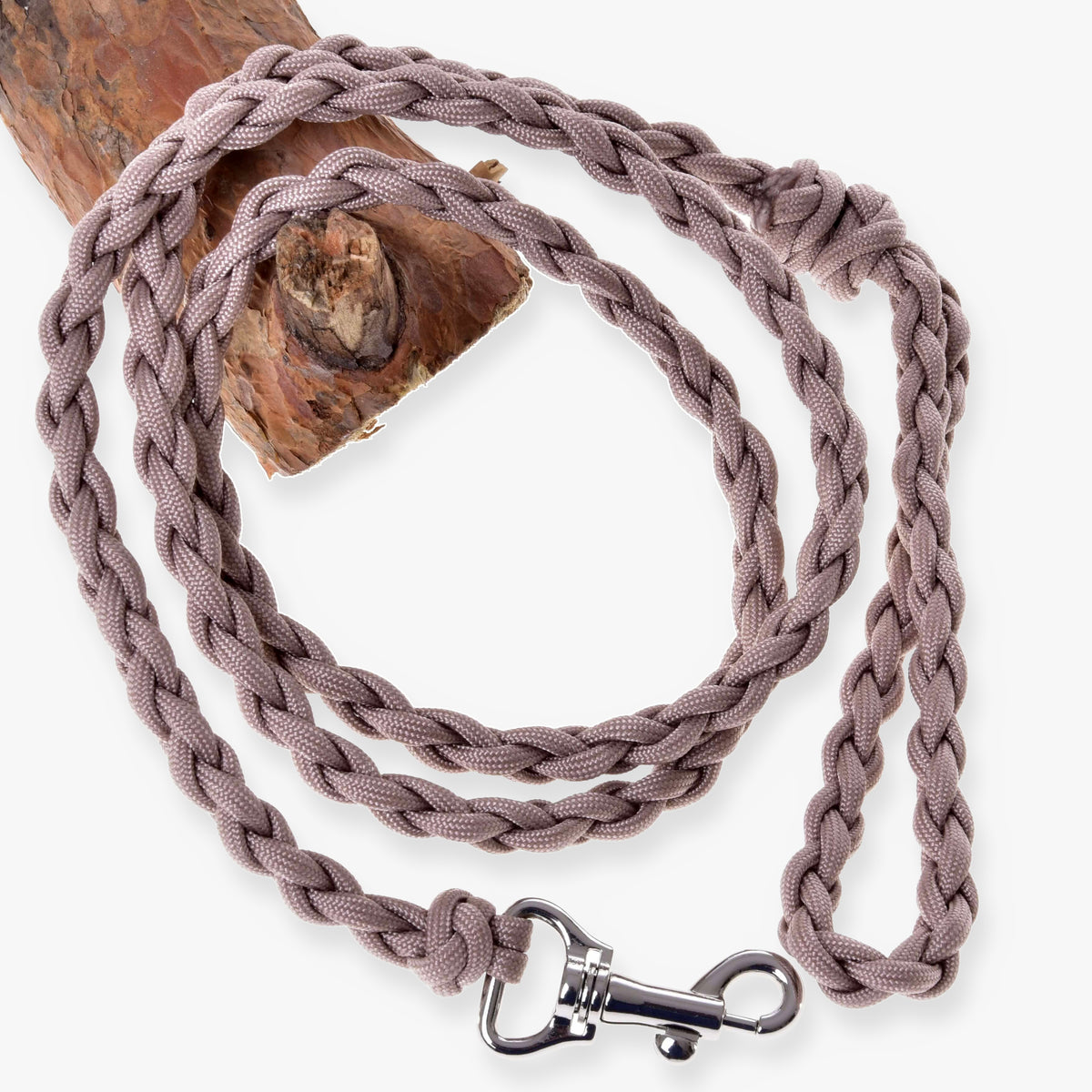 LarDen Hobby Horse Knitted Lead Rope Almond, braided paracord lead with silver snap hook draped over a wooden branch