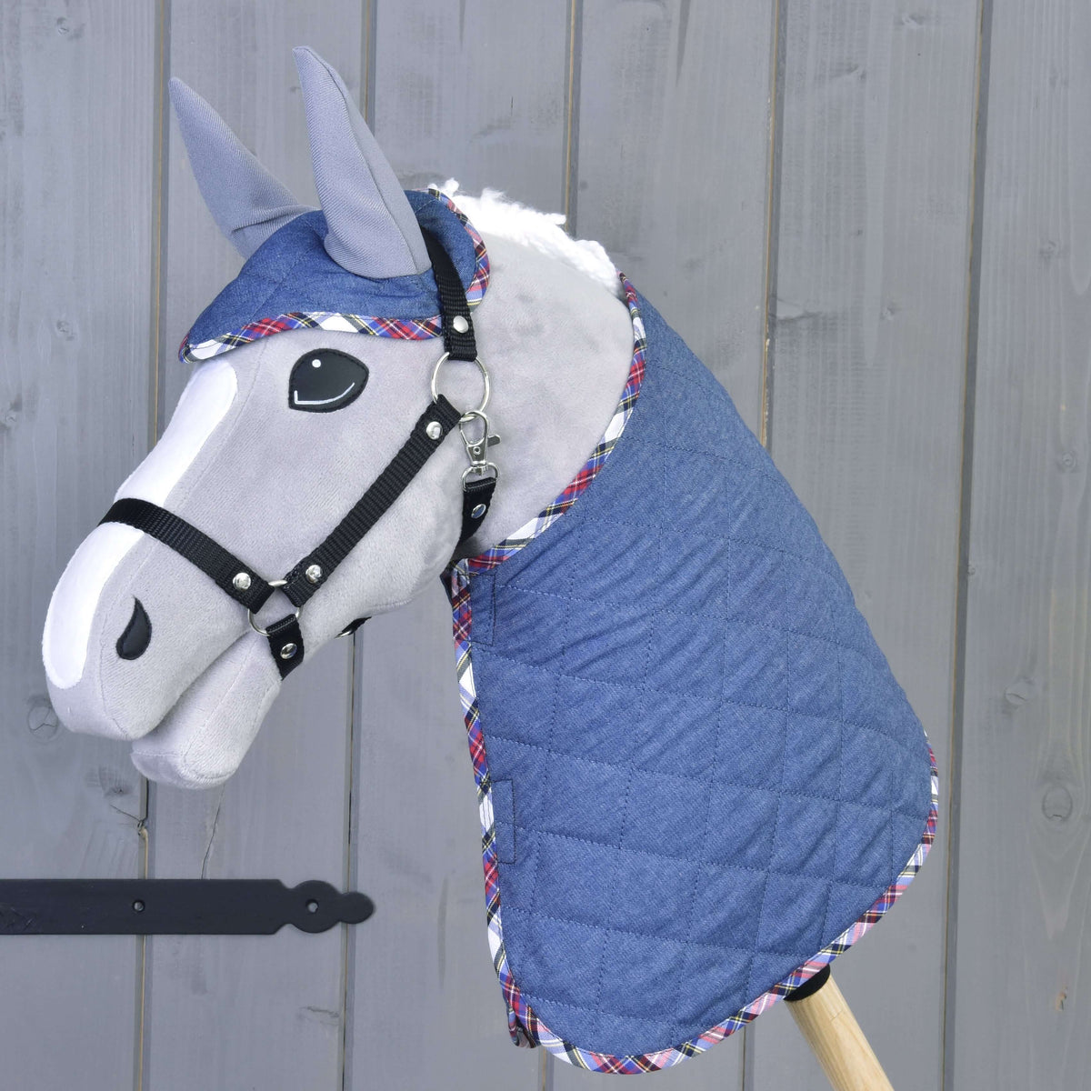 Grey Hobby Horse with a white mane wearing Set Jeans, the quilted denim blanket and ear bonnet with colourful tartan trim