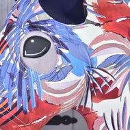 Close-up of the eye opening framed by blue, red and pink palm leaves on the Blue Jungle protective suit on a Hobby Horse