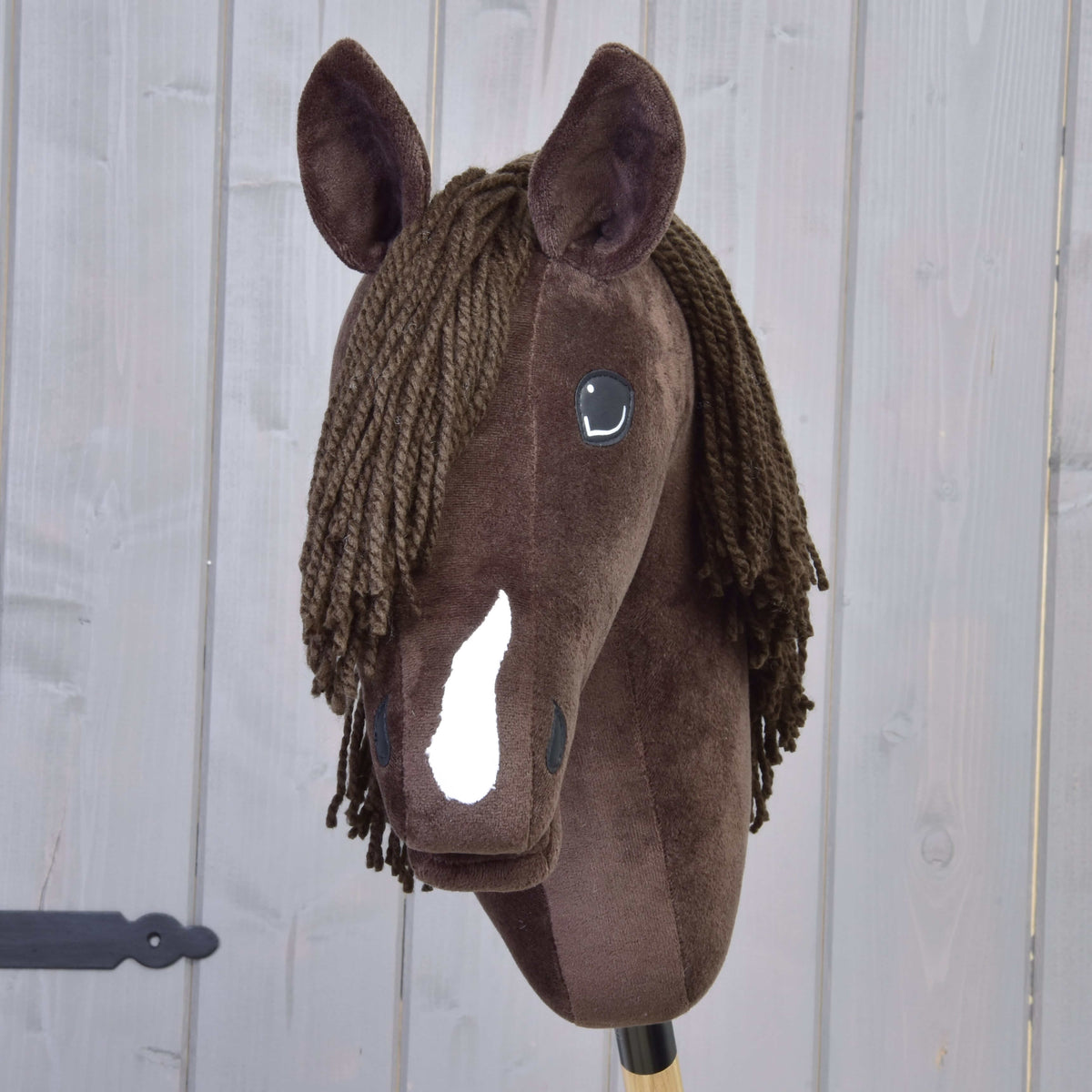Sötétbarna Hobby Horse ló elölről, kötőfék nélkül: látszik a fehér hóka és a barna fonalüstök