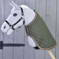 Light grey Hobby Horse in a black halter wearing the olive green quilted blanket with orange piping
