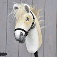 Hobby Horse Honey Pearl from the front, blond faux fur forelock between the ears and a black webbing halter