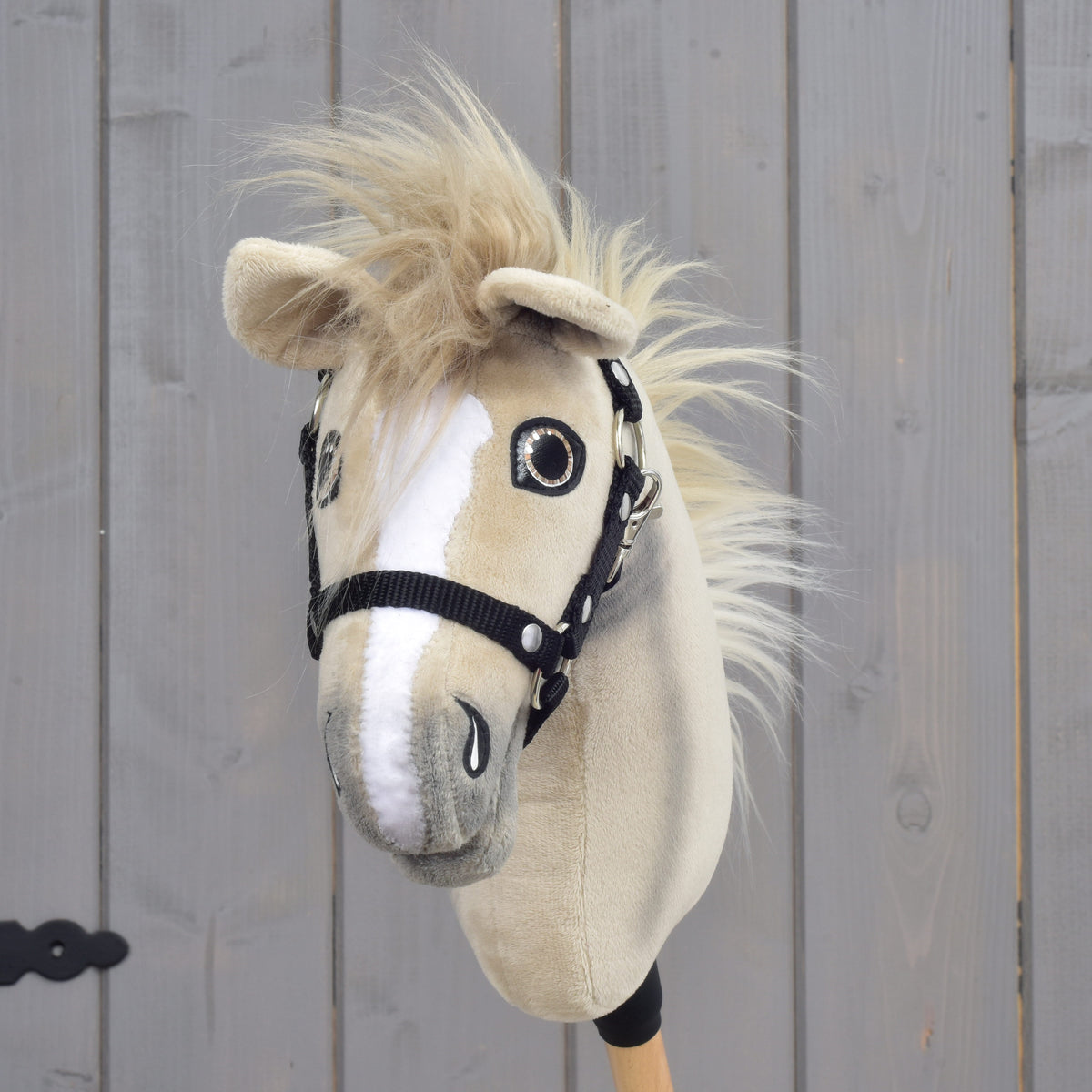 Hobby Horse Ivory Dream from the front, white blaze, sparkly eyes and a fluffy blond forelock between beige ears