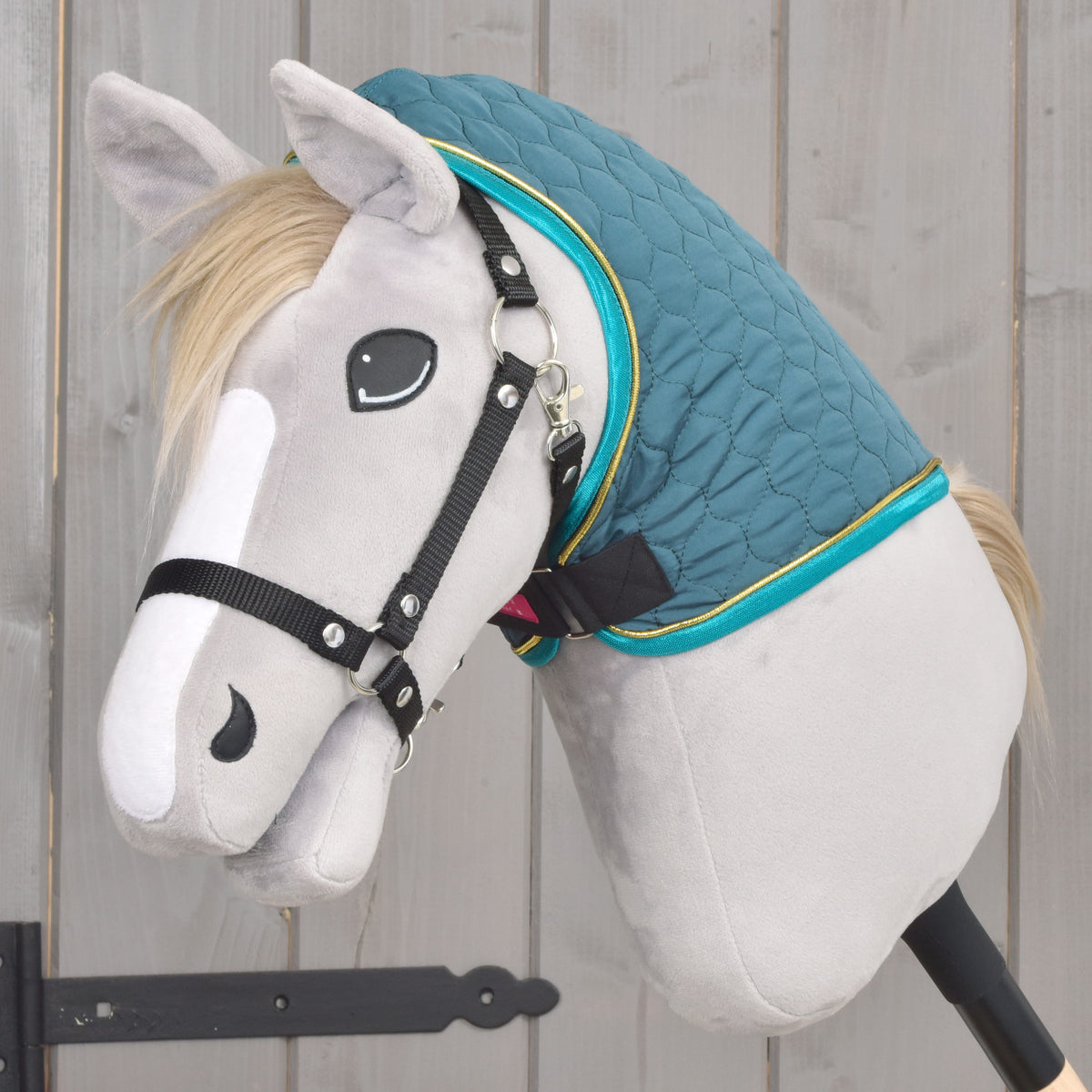 Grey Hobby Horse wearing only the dark teal Lagoon neck cover, edged in turquoise and gold, with a black halter