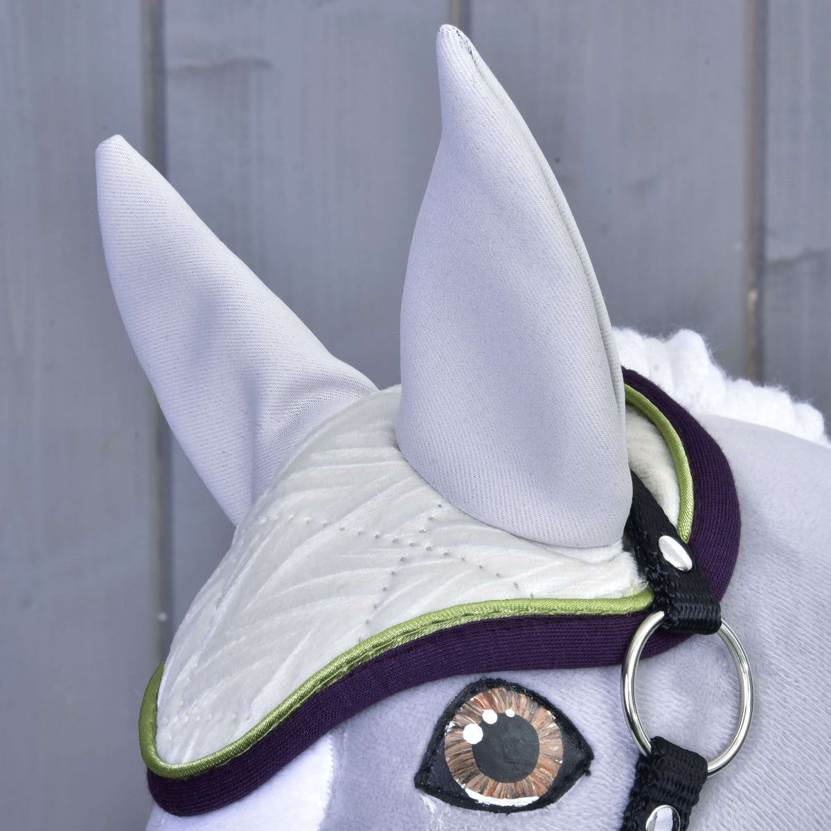 Set Leonardo ear bonnet on a grey Hobby Horse: light grey ears, ivory quilting, lime piping and purple binding