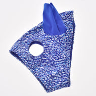 Horse Mask See laid flat, blue and white speckled stretch fabric with one royal blue ear and a round eye opening