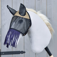 LarDen Fly Mask De Luxe Mona in black mesh with a beige woven brow panel and dark purple nose fringe on a grey Hobby Horse