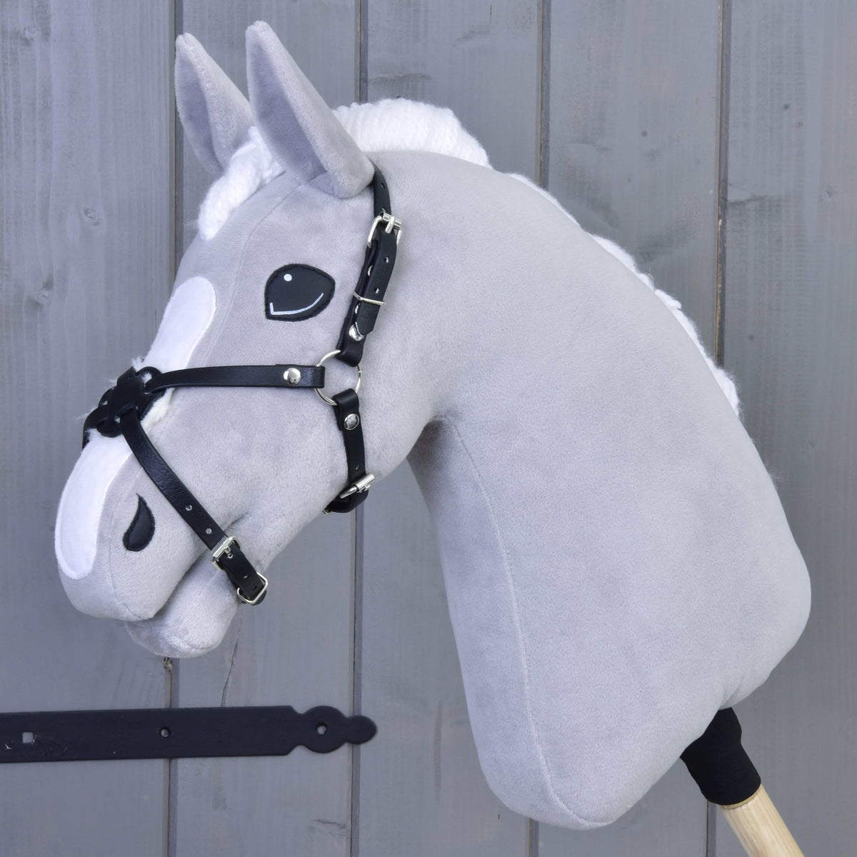 Grey plush Hobby Horse wearing the Noseband Mexico Black Padded by LarDen, black leatherette straps crossing on the nose