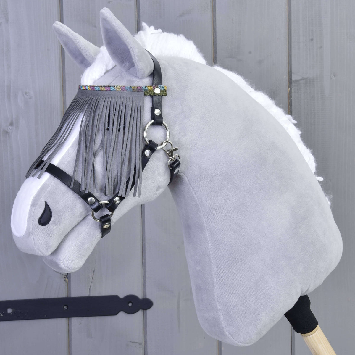 Grey plush Hobby Horse wearing the Halter black with grey fringes by LarDen, fringes falling over its eyes