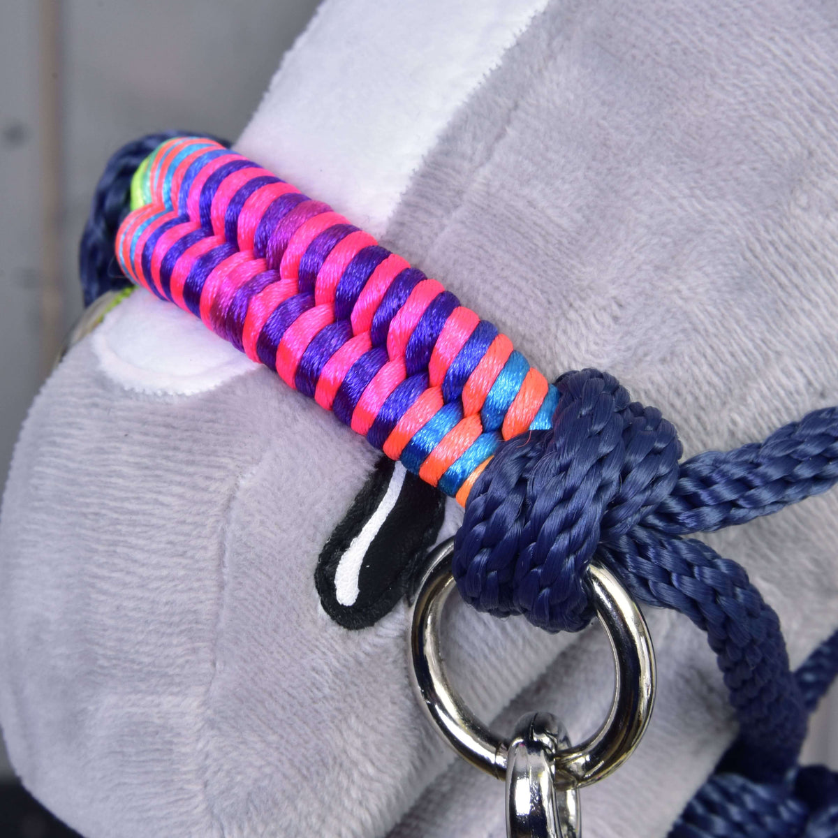 Macro detail of the neon braided noseband of the Hobby Horse Rope set Rosemary with a navy rope knot and silver ring