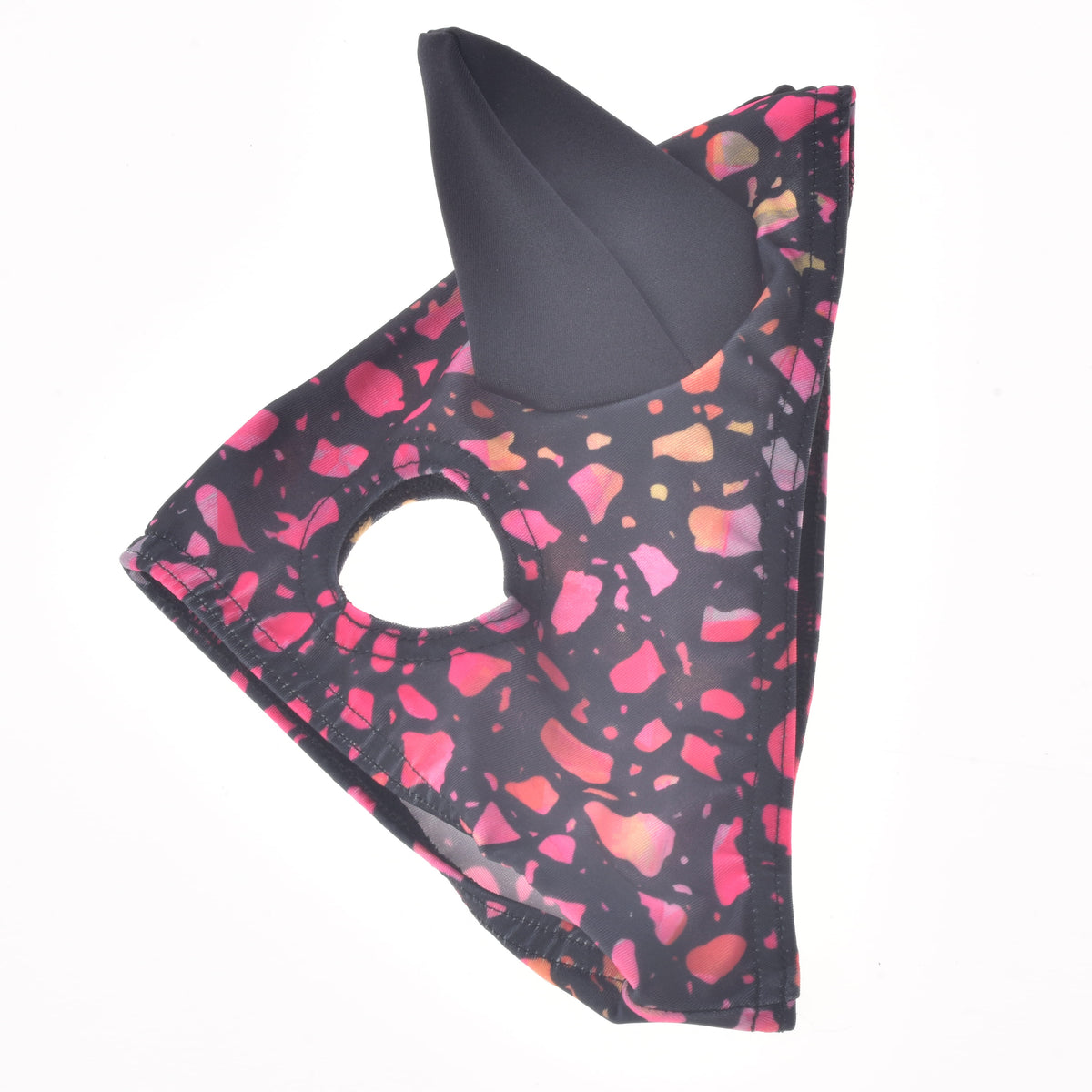 Horse Mask Roxy for Hobby Horse laid flat, black stretch fabric with pink and coral flecks, one black ear and an eye opening