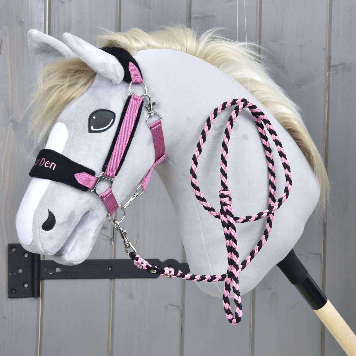Grey Hobby Horse in the Exclusive Pink halter with embroidered black noseband, the pink and black lead rope over its neck