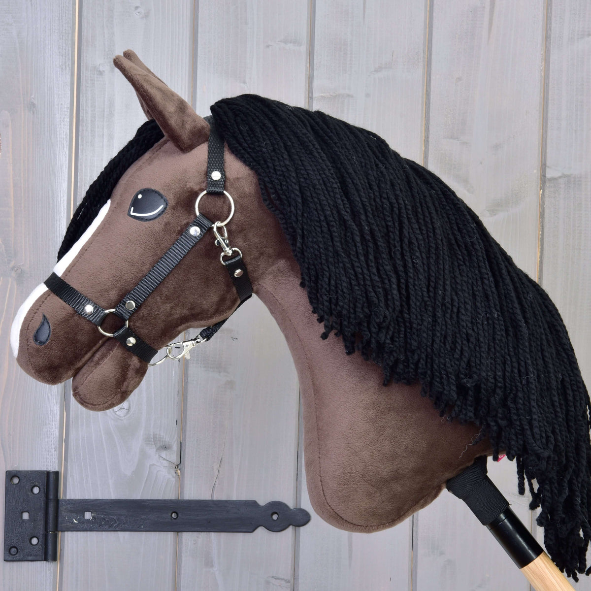 Hobby Horse Sisi ló bal profilból, a sötétbarna nyakán dús fekete fonalsörénnyel és fekete kötőfékkel