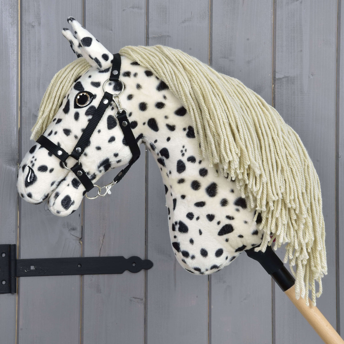 Hobby Horse Lord Valentine in left profile with the long sand-coloured yarn mane falling over the spotted neck