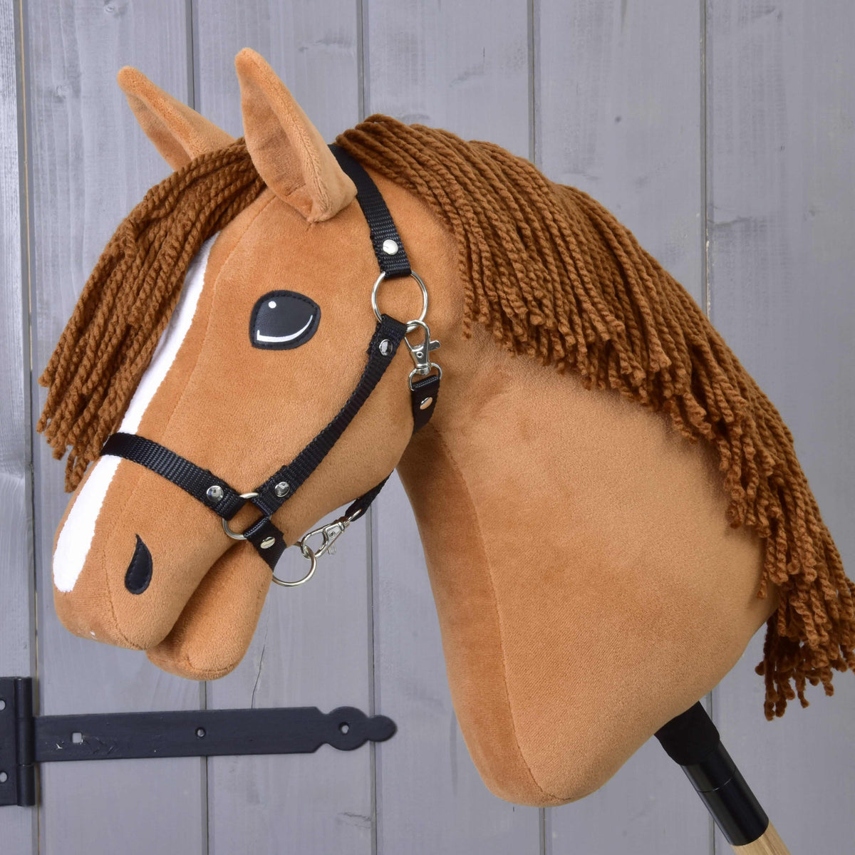 Hobby Horse Wendy with Black Halter by LarDen, a chestnut plush head with a white stripe and brown yarn mane