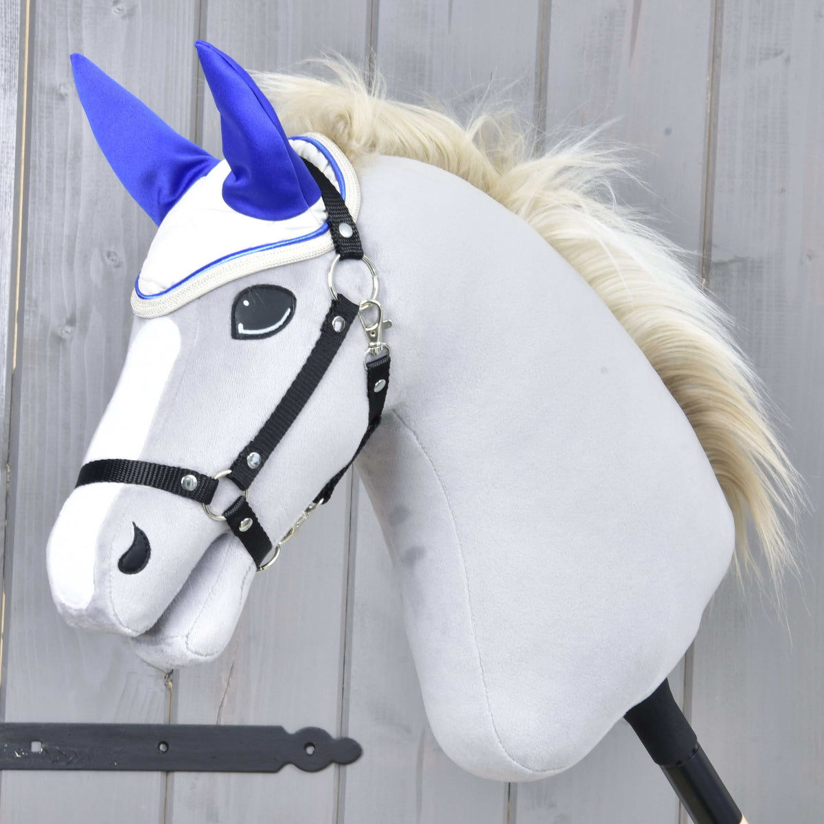 Grey Hobby Horse with a blond mane and black halter wearing the Ear Bonnet Cream Pearl with bright royal blue ears