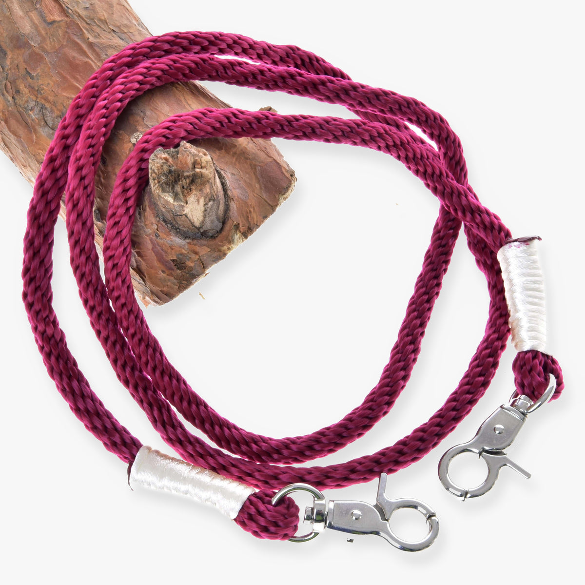 Hobby Horse Reins Czi-czi by LarDen, burgundy rope with white wrapped ends and two silver snap hooks, on a branch