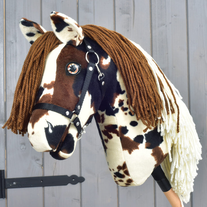 Hobby Horse Dakota with Black Halter by LarDen, cream plush with brown and black patches and a brown and cream yarn mane