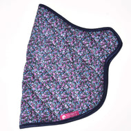 Quilted flower blanket laid flat from the side, small pink, lilac and blue flowers, navy binding and a pink LarDen label