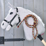 Light grey Hobby Horse in a black halter with the braided black, red and yellow rope stripe Flag lead rope