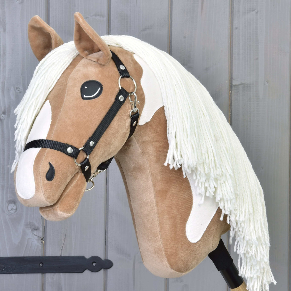 Hobby Horse Fury with Black Halter by LarDen, a tan plush head with a white blaze, white patches and a cream yarn mane