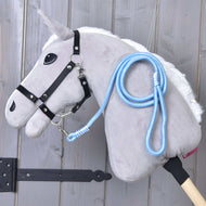 Light grey Hobby Horse in a black halter with the light blue rope stripe Heaven lead rope clipped on and draped over its neck