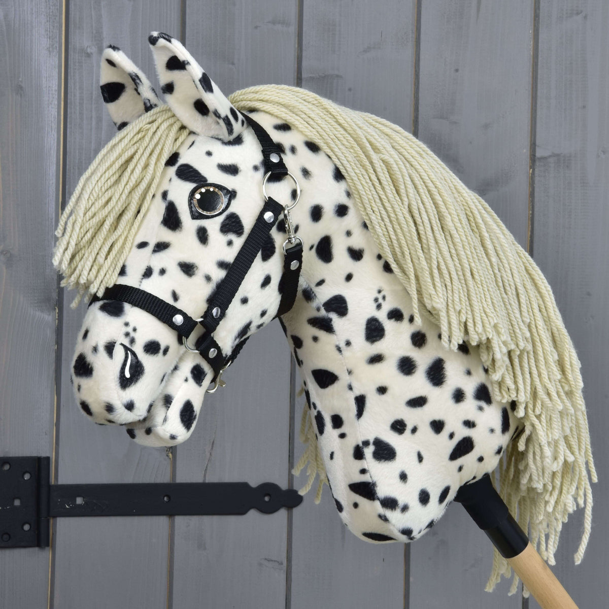 Hobby Horse Lord Valentine with Black Halter by LarDen, a cream plush head with black spots and a long sand yarn mane