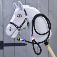 Grey plush Hobby Horse with a black halter, the black rainbow-wrapped lead rope clipped to its chin and coiled beside it