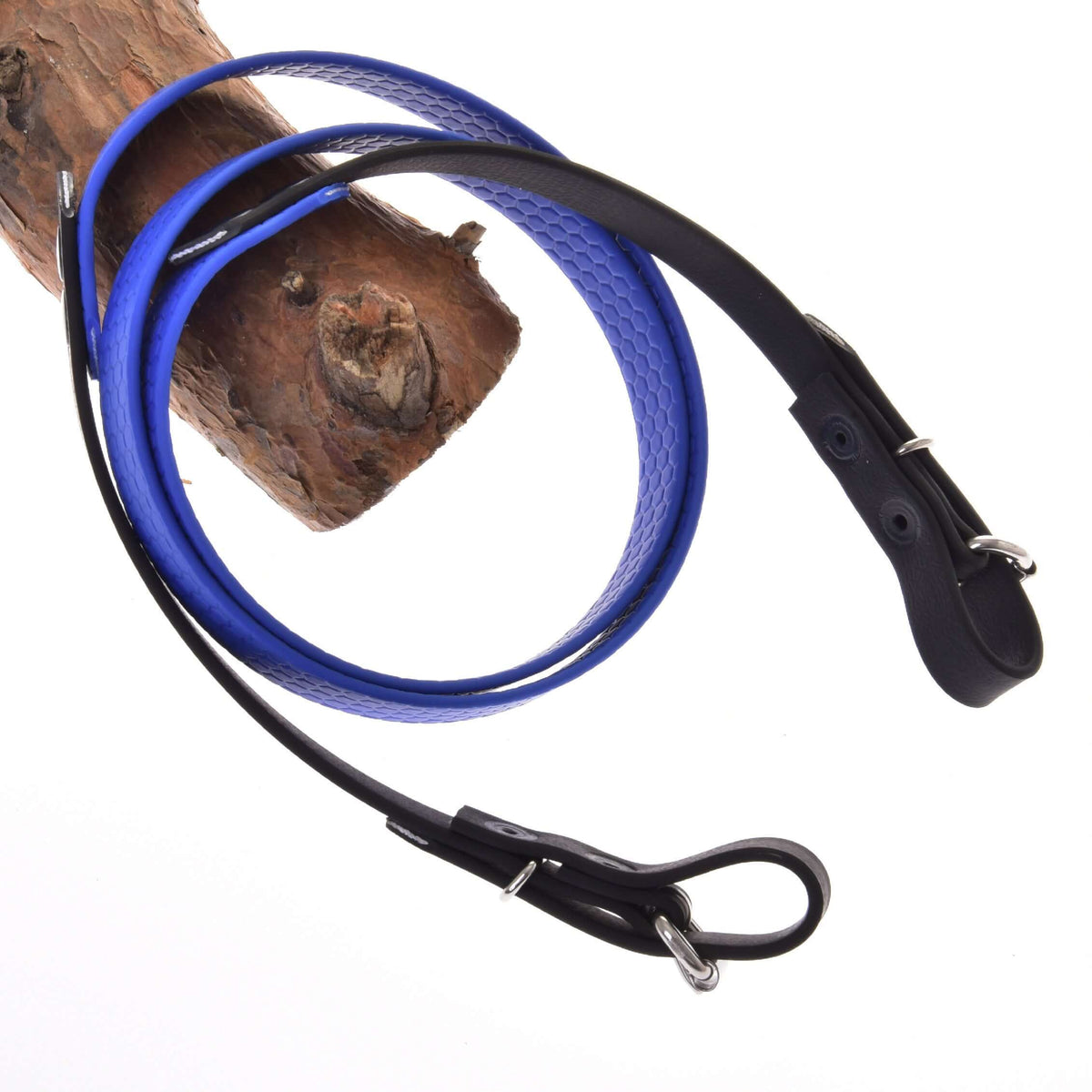 LarDen Hobby Horse Rubberized reins blue with a grippy honeycomb texture and black buckled ends, over a branch