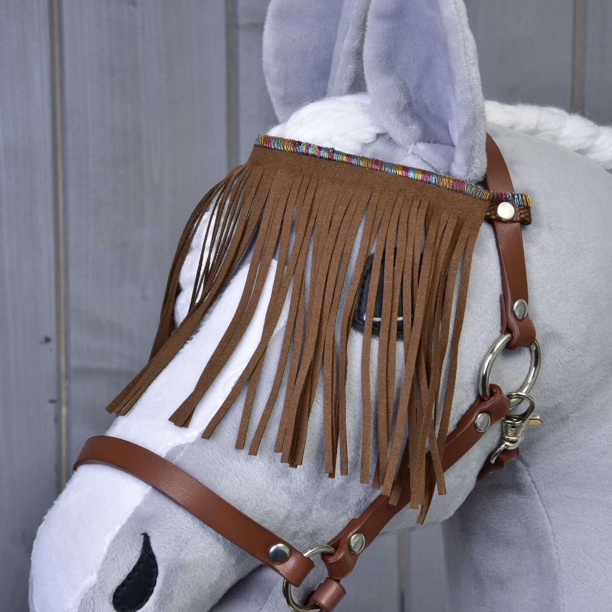 Close-up of the brown fringed browband with a colourful woven trim on the brown Hobby Horse halter