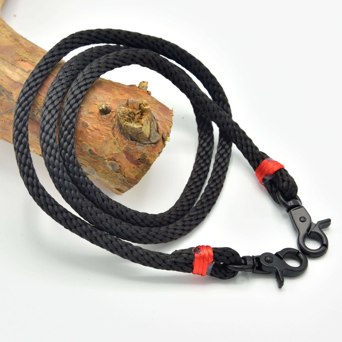 LarDen Hobby Horse kantárszár Spark, fekete fonott kötélből, piros tekeréssel és fekete karabinerekkel, faágon